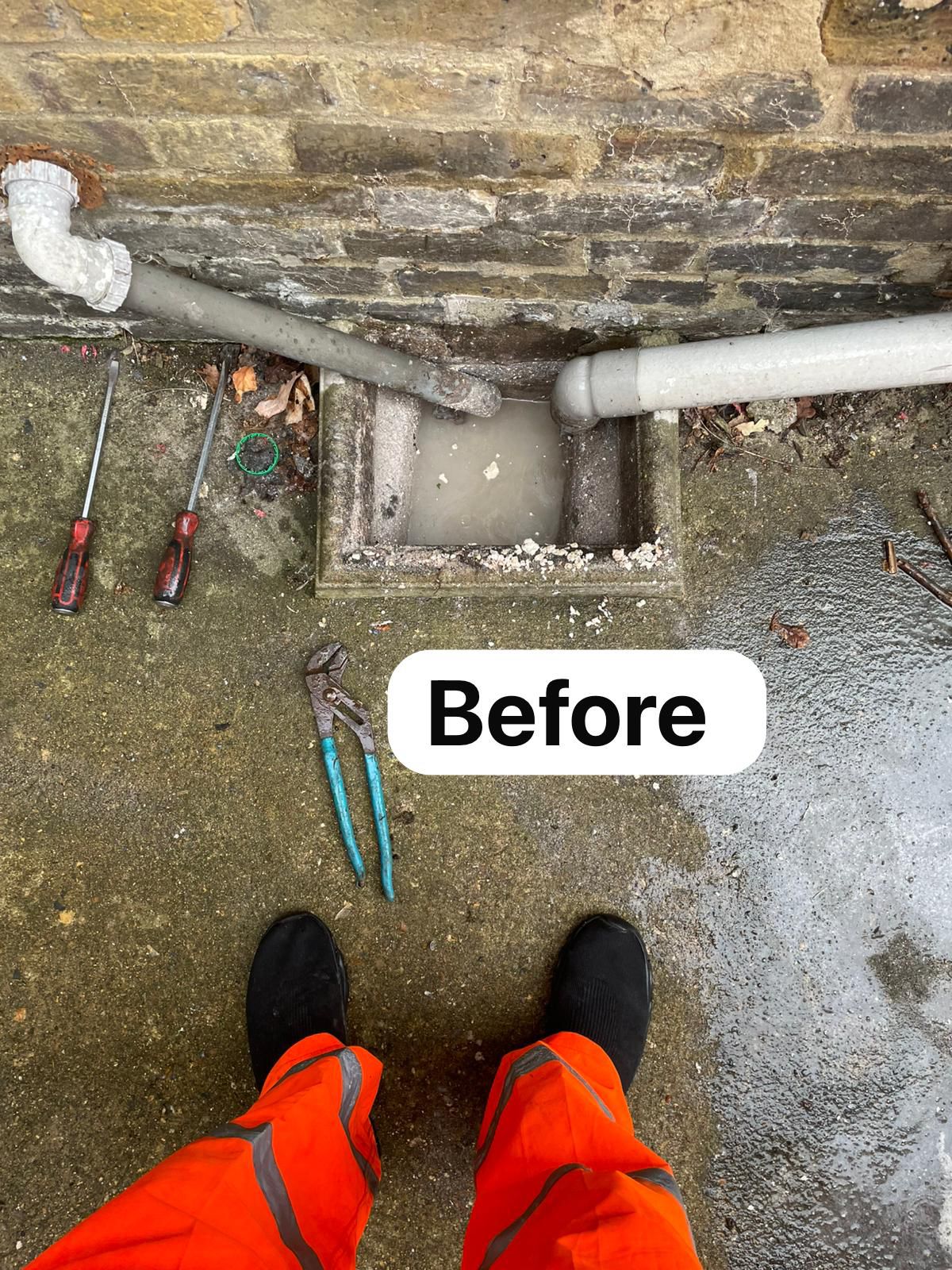 Blocked outside drain overflowing — before